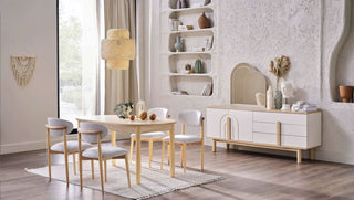 Mona dining room with wooden table and chairs, white sideboard, and decorative elements.