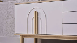 White cabinet with wooden accents against a neutral background