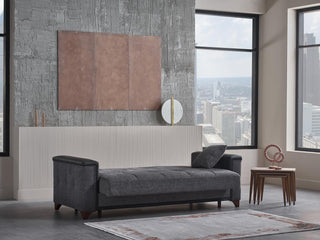 Modern living room with a gray sofa, large windows, and cityscape view.