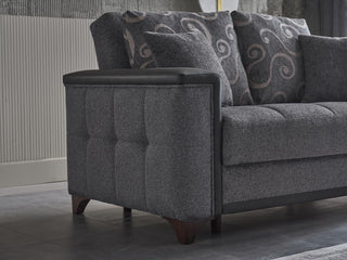 Gray sofa with patterned cushions in a room setting.