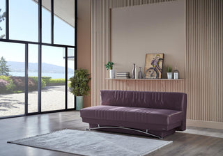 Purple sofa in a modern living room with large windows and decorative items.