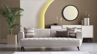 Modern living room with a gray sofa, decorative pillows, and a sideboard.