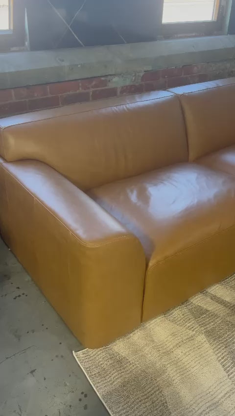 Dakota Full Leather Sectional with modular design and plush seating for ultimate comfort.