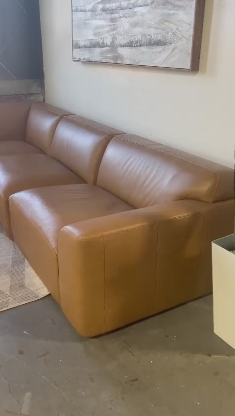Dakota Full Leather Sectional in camel color, featuring a sleek modern design and spacious seating